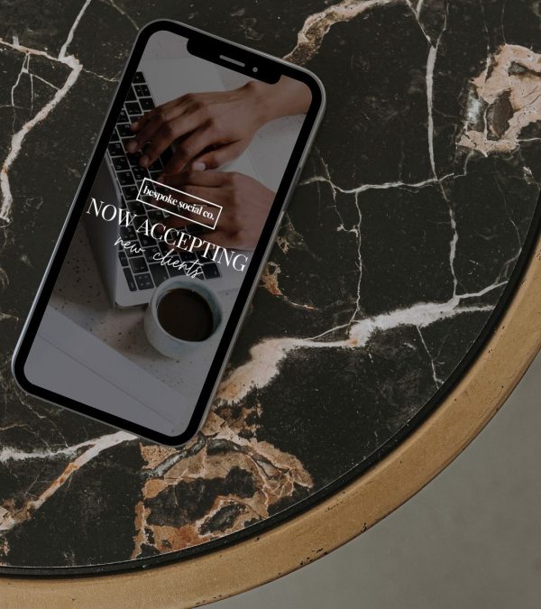 iphone on black marble coffee table bespoke-social-co-social-media-management-and-strategy-services