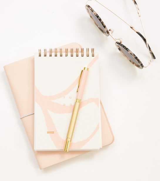 sunglasses-and-pink-notepad-on-desk-bespoke-social-co-social-media-management-and-strategy-services